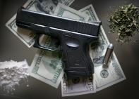 Gun & a Single Bullet on Top of Money Near Marijuana & White Powder